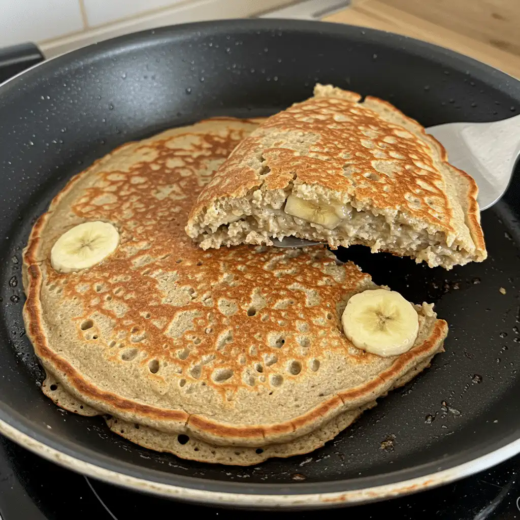 Cooking banana protein pancake on skillet