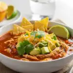Chicken taco soup bowl served with toppings and sides