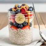 High-protein overnight oats in a jar with berries and nut butter