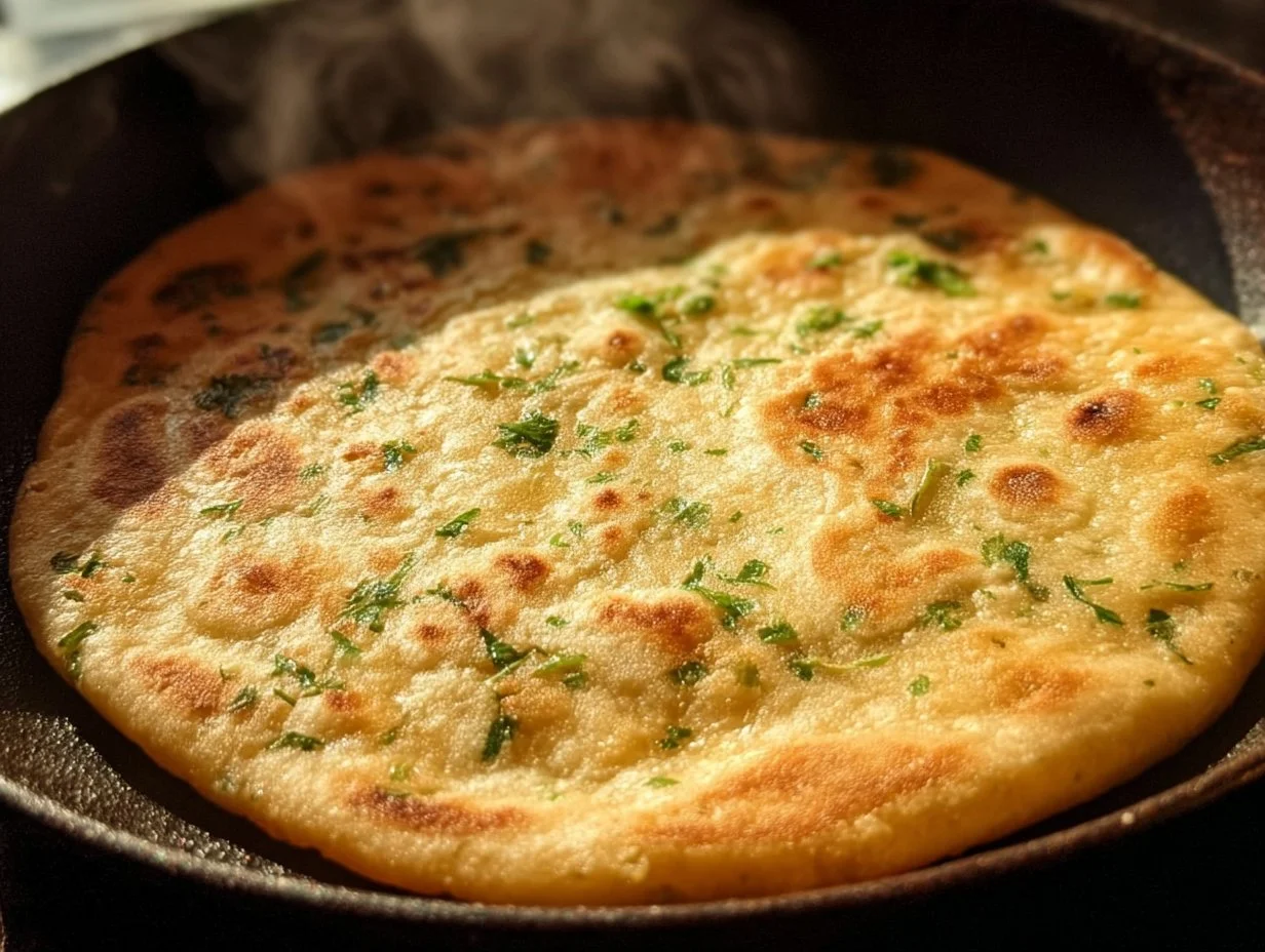 Homemade garlic flatbread served with fresh herbs and olive oil