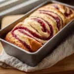 Homemade perfect jam swirl gluten-free bread sliced on a wooden board
