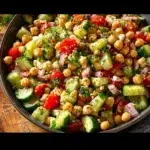 Healthy chickpea cucumber salad with fresh vegetables and dressing